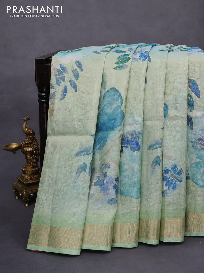 Crushed tissue saree pastel green with allover floral digital prints and zari woven border