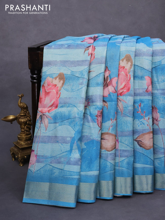 Crushed tissue saree light blue with allover floral digital prints and zari woven border