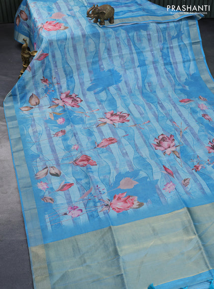 Crushed tissue saree light blue with allover floral digital prints and zari woven border