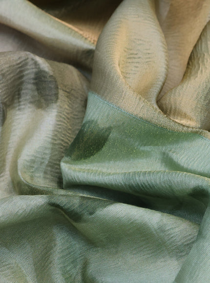 Crushed tissue saree pastel green with allover floral digital prints and zari woven border