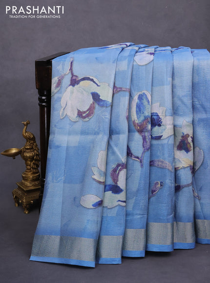 Crushed tissue saree light blue with allover floral digital prints and zari woven border