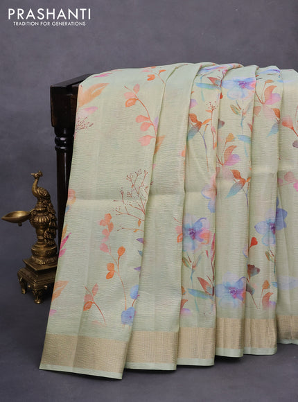 Crushed tissue saree pastel green with allover digital prints and zari woven border