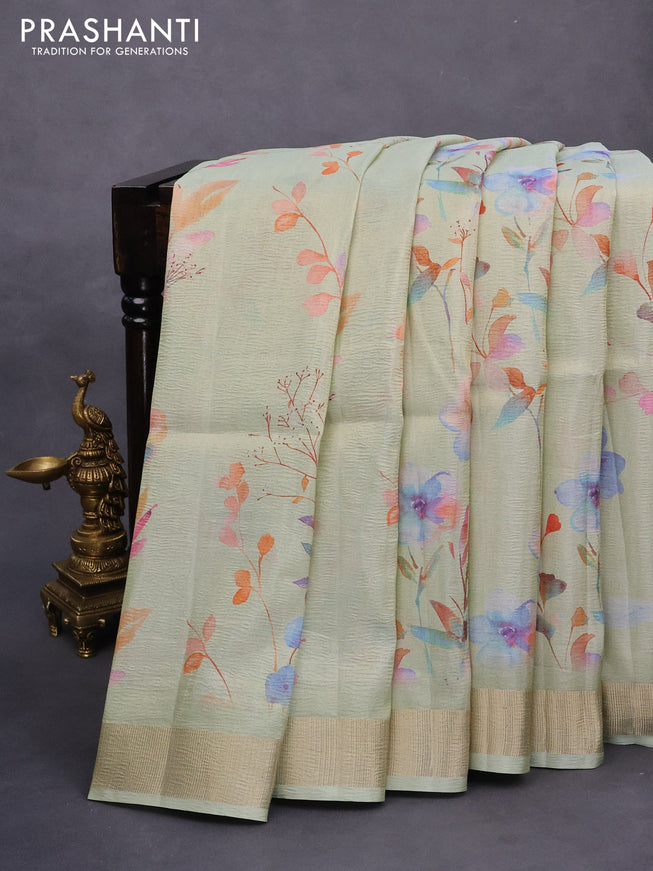 Crushed tissue saree pastel green with allover digital prints and zari woven border