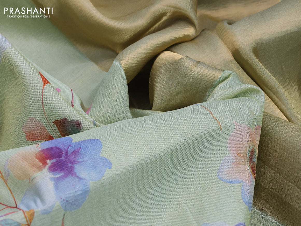 Crushed tissue saree pastel green with allover digital prints and zari woven border