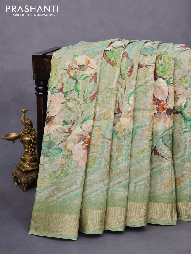 Crushed tissue saree pastel green with allover digital prints and zari woven border