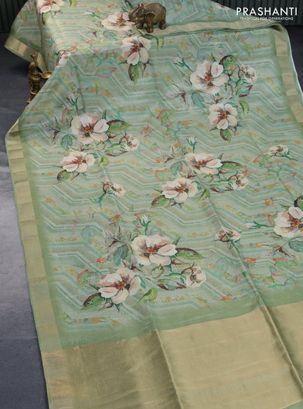 Crushed tissue saree pastel green with allover digital prints and zari woven border