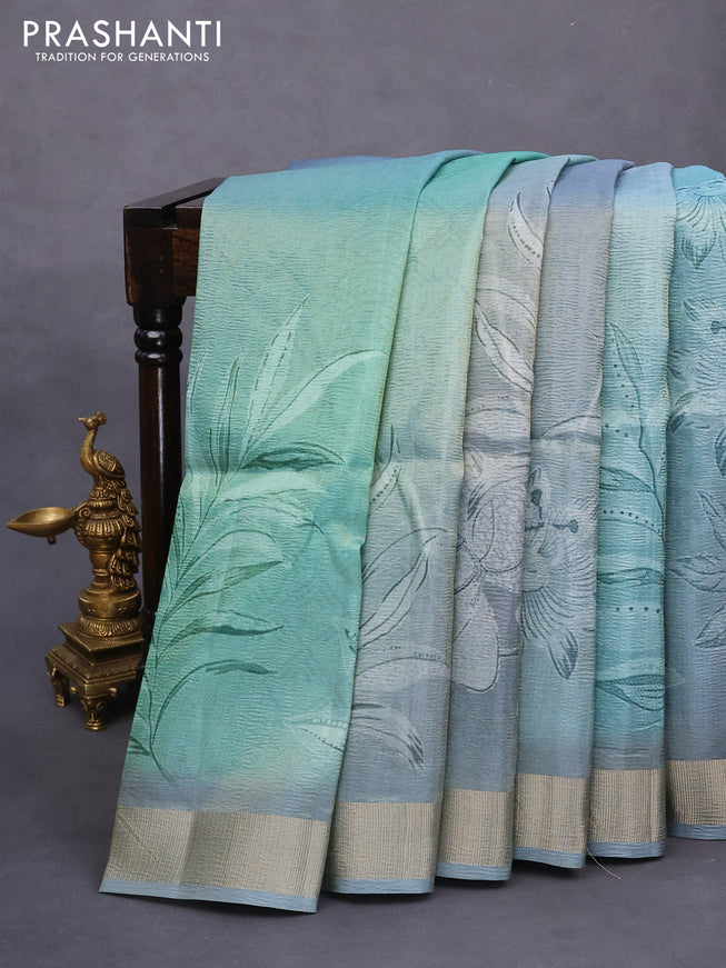 Crushed tissue saree pastel blue with allover digital prints and zari woven border