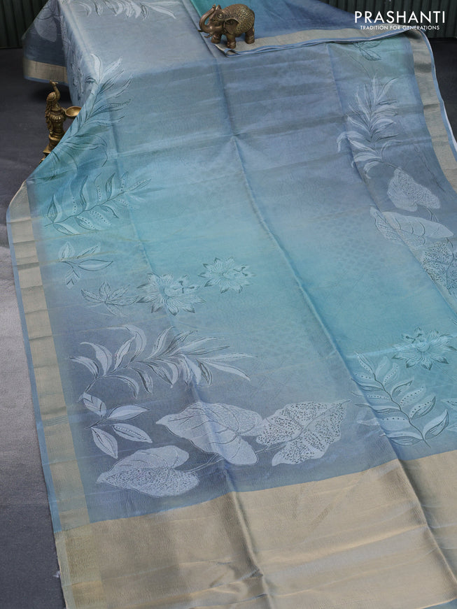 Crushed tissue saree pastel blue with allover digital prints and zari woven border