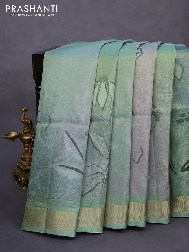 Crushed tissue saree pastel green with allover digital prints and zari woven border