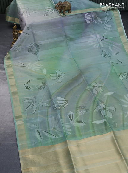 Crushed tissue saree pastel green with allover digital prints and zari woven border