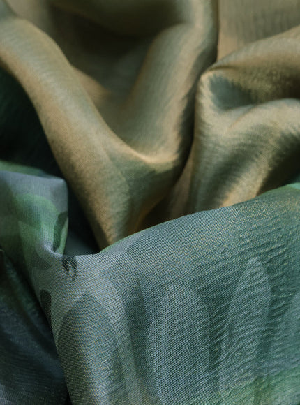 Crushed tissue saree pastel green with allover digital prints and zari woven border