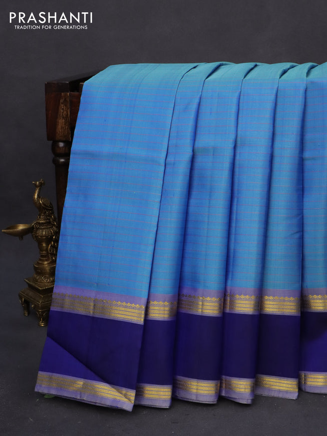 Pure kanchipuram silk saree blue shade and blue with allover checked pattern and rettapet zari woven border