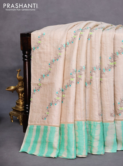 Pure tussar silk saree off white and teal green with allover embroidery work and tie & dye border