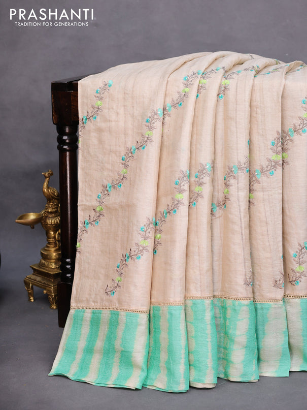 Pure tussar silk saree off white and teal green with allover embroidery work and tie & dye border