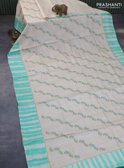 Pure tussar silk saree off white and teal green with allover embroidery work and tie & dye border