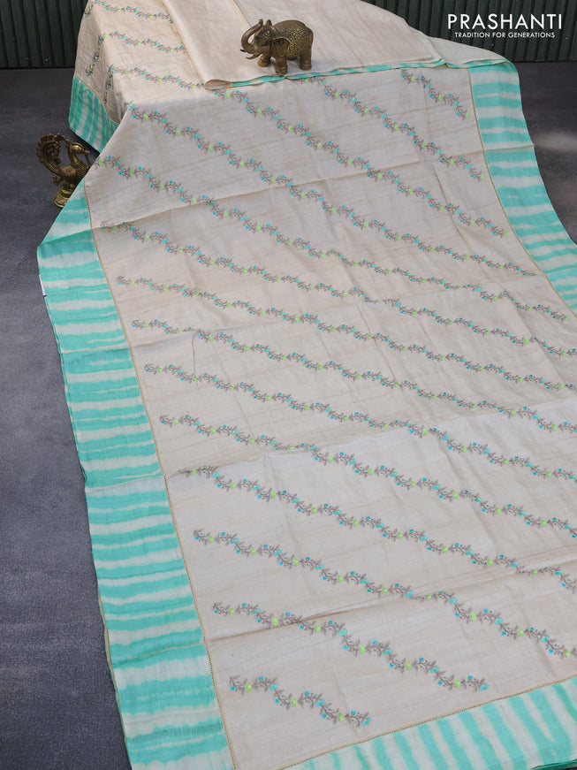 Pure tussar silk saree off white and teal green with allover embroidery work and tie & dye border