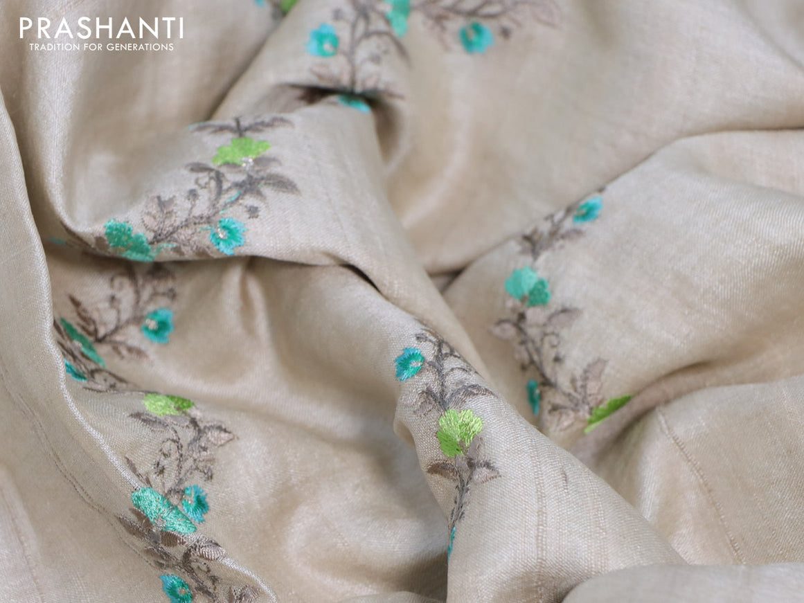 Pure tussar silk saree off white and teal green with allover embroidery work and tie & dye border