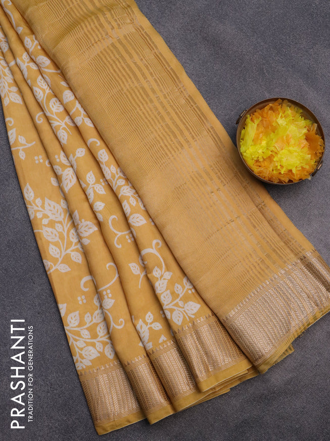 Assam silk saree yellow with allover prints and zari woven border