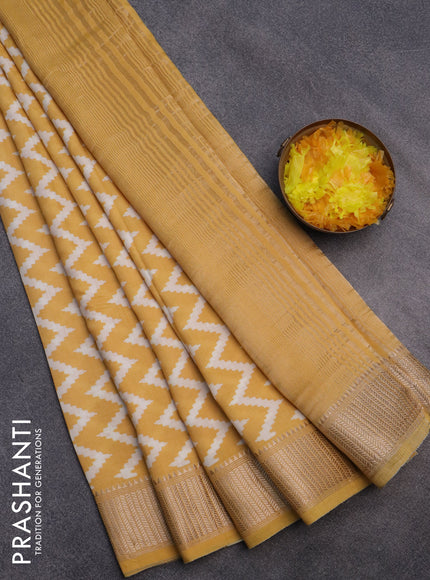 Assam silk saree yellow with allover zig zag prints and zari woven border