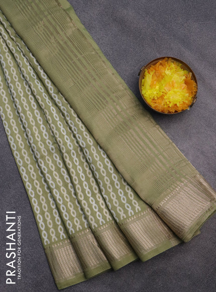 Assam silk saree pastel green with allover prints and zari woven border