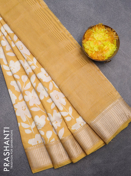 Assam silk saree mango yellow with allover floral prints and zari woven border