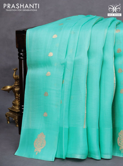 Banarasi organza saree teal shade with allover zari weaves and zari woven butta border