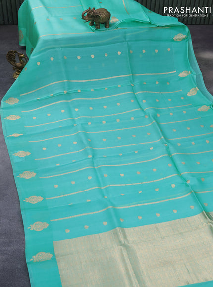 Banarasi organza saree teal shade with allover zari weaves and zari woven butta border