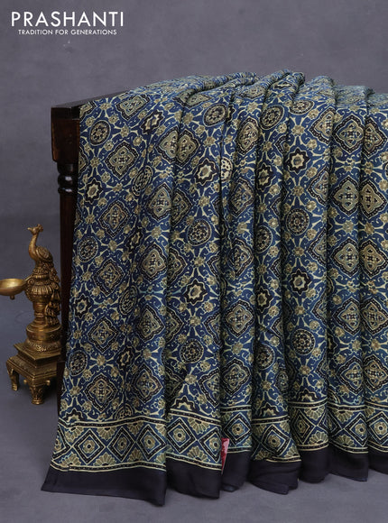 Modal silk saree peacock blue and black with allover ajrakh prints and printed border