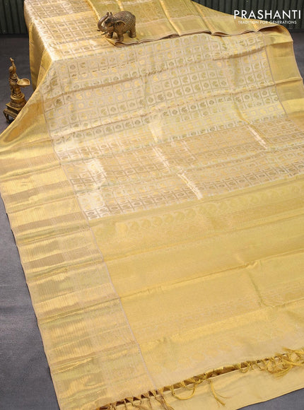 Pure kanjivaram tissue silk saree gold with allover zari woven brocade weaves and long zari woven border