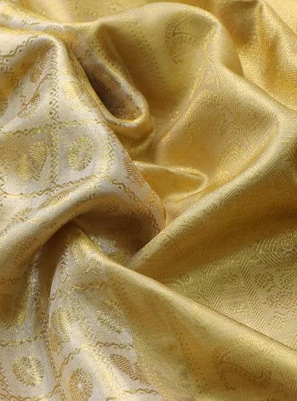 Pure kanjivaram tissue silk saree gold with allover zari woven brocade weaves and long zari woven border