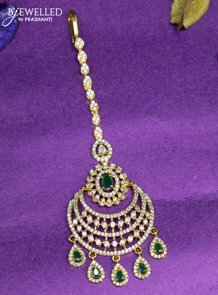 Zircon maang tikka with emerald & cz stones and hangings in gold finish