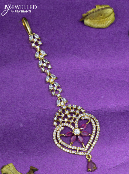 Zircon maang tikka with ruby & cz stones and hangings in gold finish