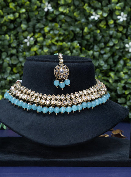 Kundan necklace with ice blue beads hanging and maang tikka