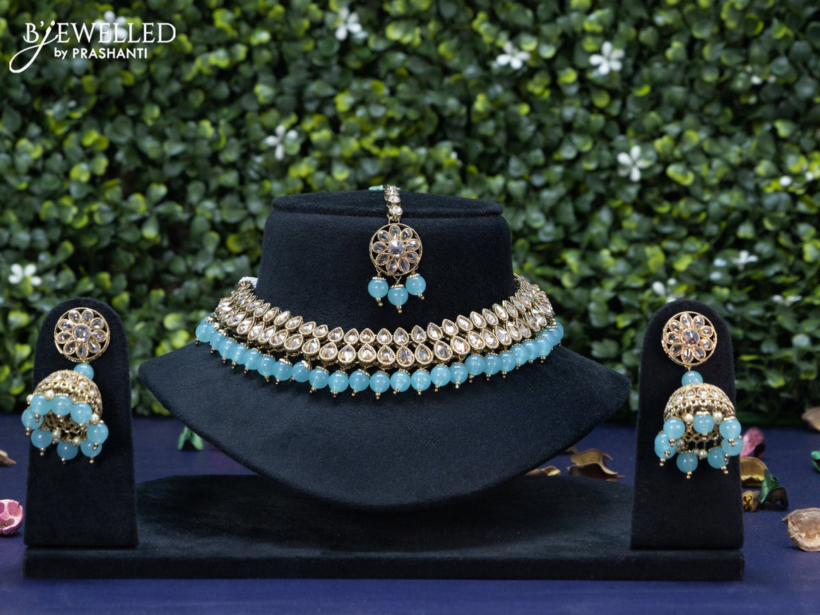 Kundan necklace with ice blue beads hanging and maang tikka