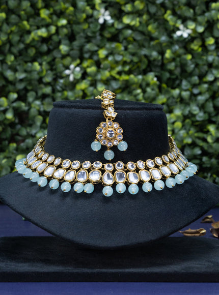 Kundan necklace with mint green beads hanging and maang tikka