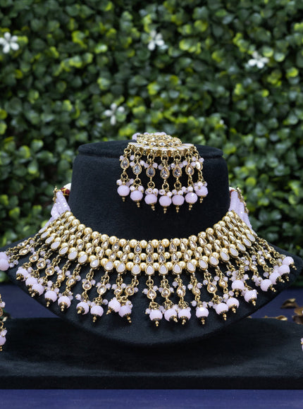 Kundan necklace with baby pink beads hanging and maang tikka