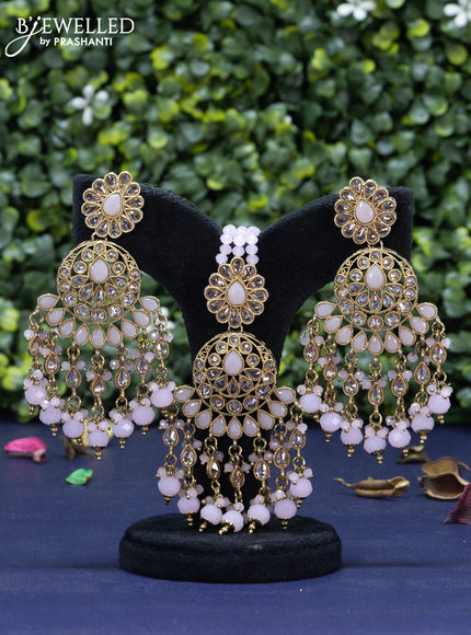 Kundan necklace with baby pink beads hanging and maang tikka