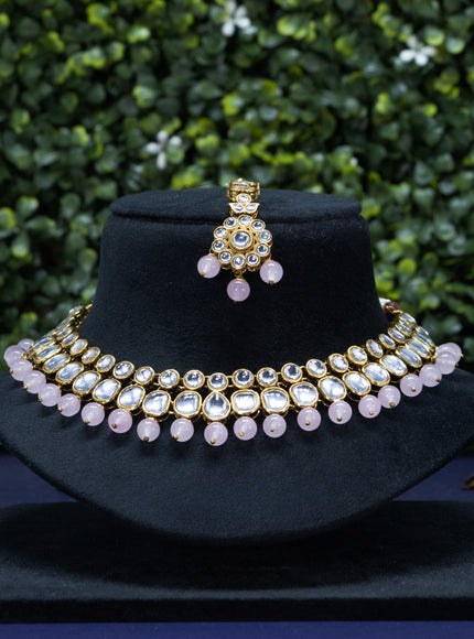 Kundan necklace with baby pink beads hanging and maang tikka