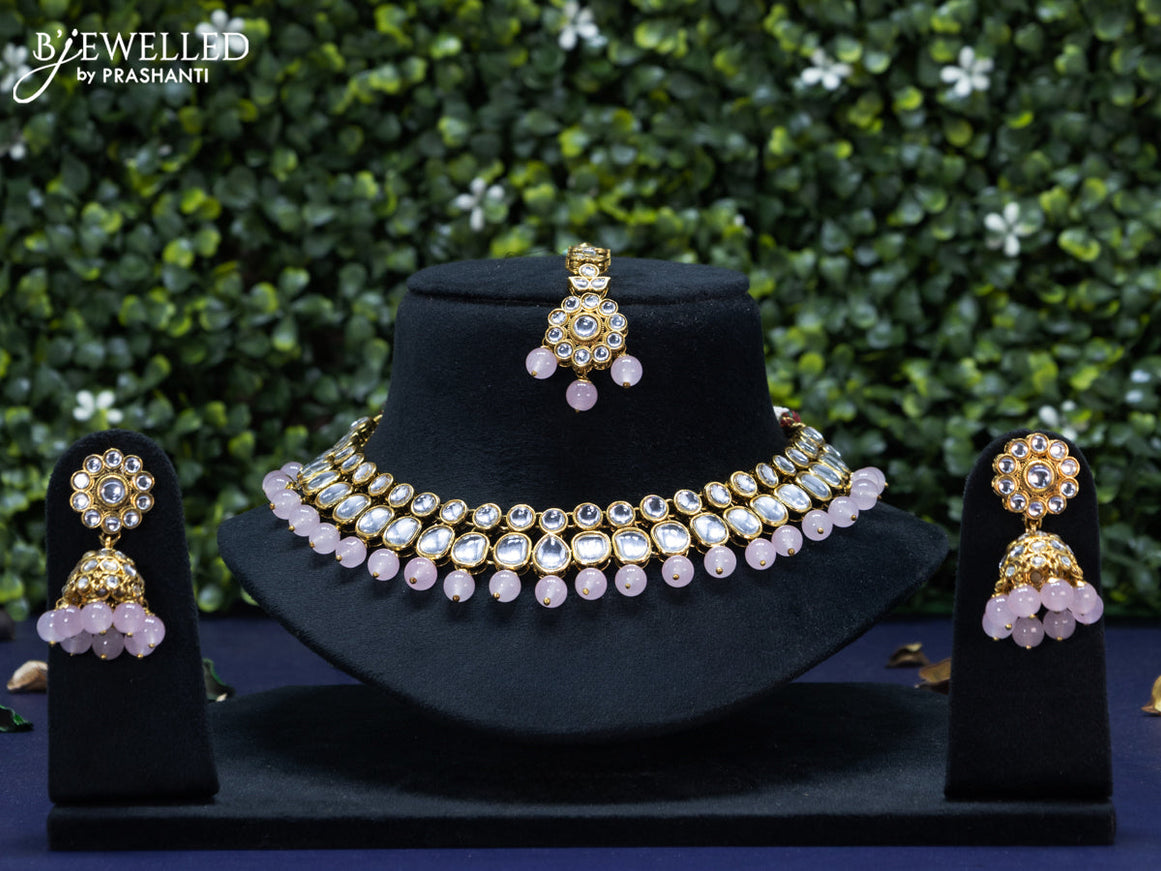 Kundan necklace with baby pink beads hanging and maang tikka