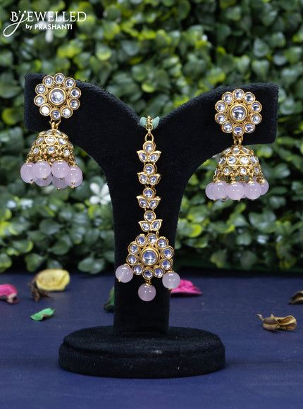 Kundan necklace with baby pink beads hanging and maang tikka