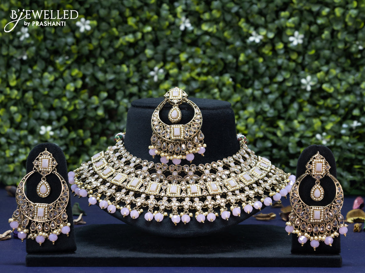 Kundan necklace with baby pink beads hanging and maang tikka