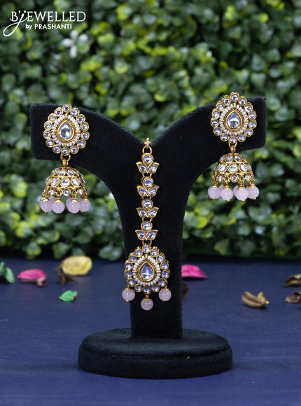 Kundan necklace with baby pink beads hanging and maang tikka