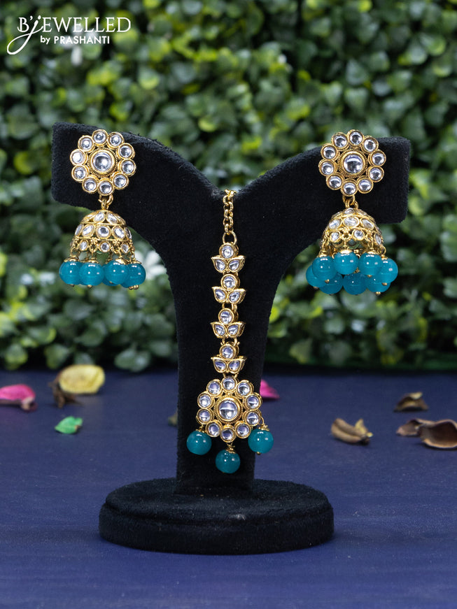 Kundan necklace with blue beads hanging and maang tikka