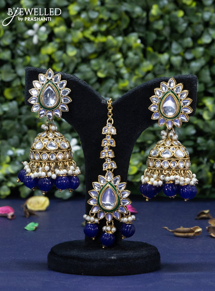 Kundan necklace with blue beads hanging and maang tikka