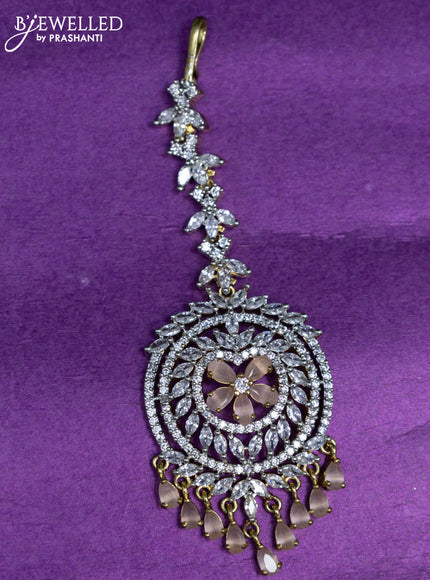 Zircon maang tikka with peach & cz stones and hangings in gold finish