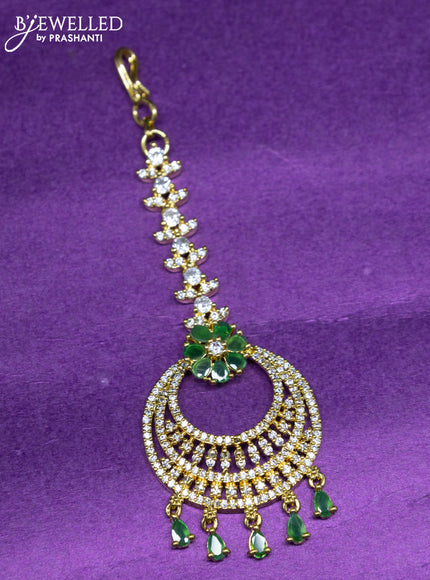 Zircon maang tikka with emerald & cz stones and hangings in gold finish