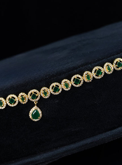 Zircon hip chain with emerald & cz stones and hanging in gold finish