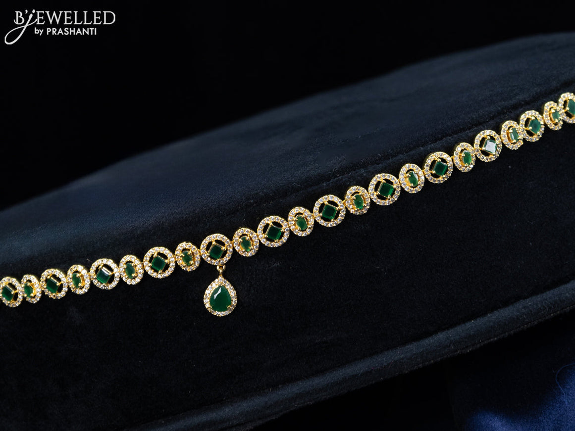 Zircon hip chain with emerald & cz stones and hanging in gold finish