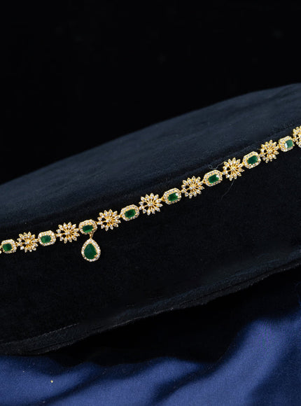 Zircon hip chain with emerald & cz stones and hanging in gold finish