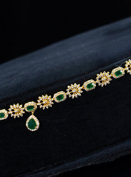 Zircon hip chain with emerald & cz stones and hanging in gold finish